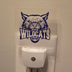 Frosted acrylic night light with a purple Wildcats mascot design, plugged into a wall outlet