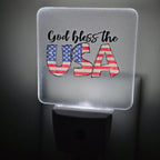 Frosted acrylic night light with a "God Bless the USA" American flag design, glowing in a dark room