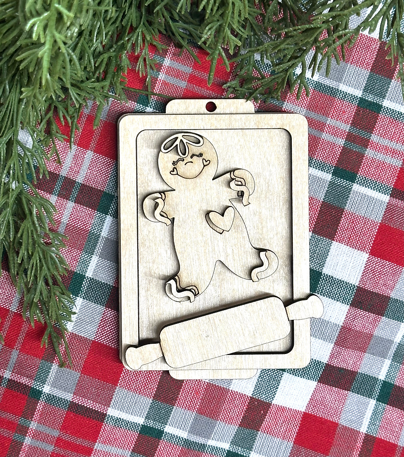 Unpainted layered wood gingerbread man on a baking sheet Christmas ornament with rolling pin, from Rise and Shine Gifts in Dothan, Alabama SHINE-OR-019