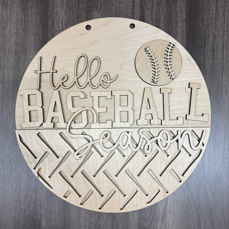 Wooden round sign with 'Hello Baseball Season' text and a baseball graphic on a wooden background