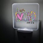 Frosted acrylic night light with a colorful heart and leopard print "I am Loved, John 3:16" design, glowing in a dark room