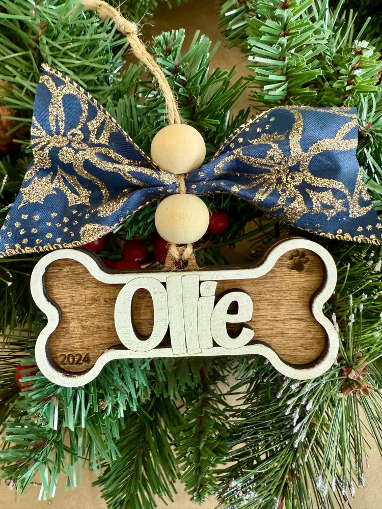 Personalized dog bone name layered wood Christmas ornament with paw print and year, cut by Rise and Shine Gifts in Dothan, Alabama OR-035