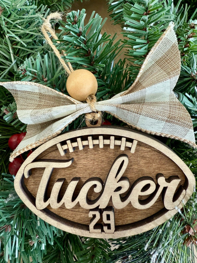Personalized football name and jersey number layered wood Christmas ornament with bow, cut by Rise and Shine Gifts in Dothan, Alabama OR-034