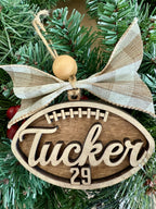 Personalized football name and jersey number layered wood Christmas ornament with bow, cut by Rise and Shine Gifts in Dothan, Alabama OR-034