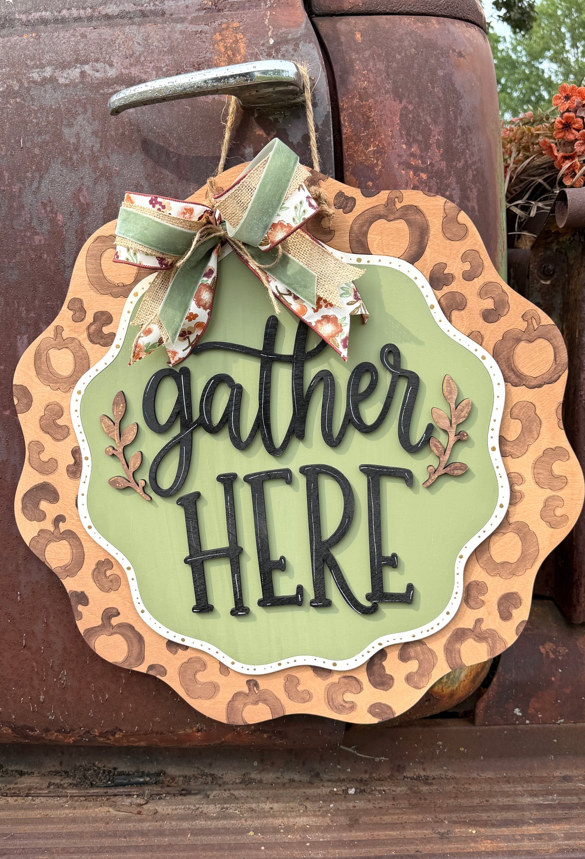 Close-up of hand-painted Gather Here leopard pumpkin Thanksgiving door hanger, made by Rise and Shine Gifts in Dothan, Alabama - SHINE-DH-009
