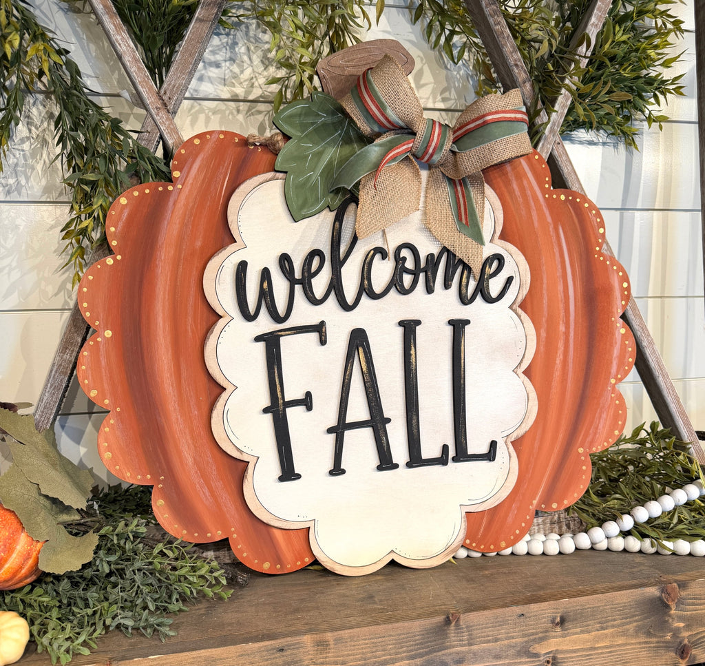 Welcome Fall scalloped pumpkin door hanger, hand-painted orange layered wood fall sign with burlap bow, cut by Rise and Shine Gifts in Dothan, Alabama - SHINE-DH-011