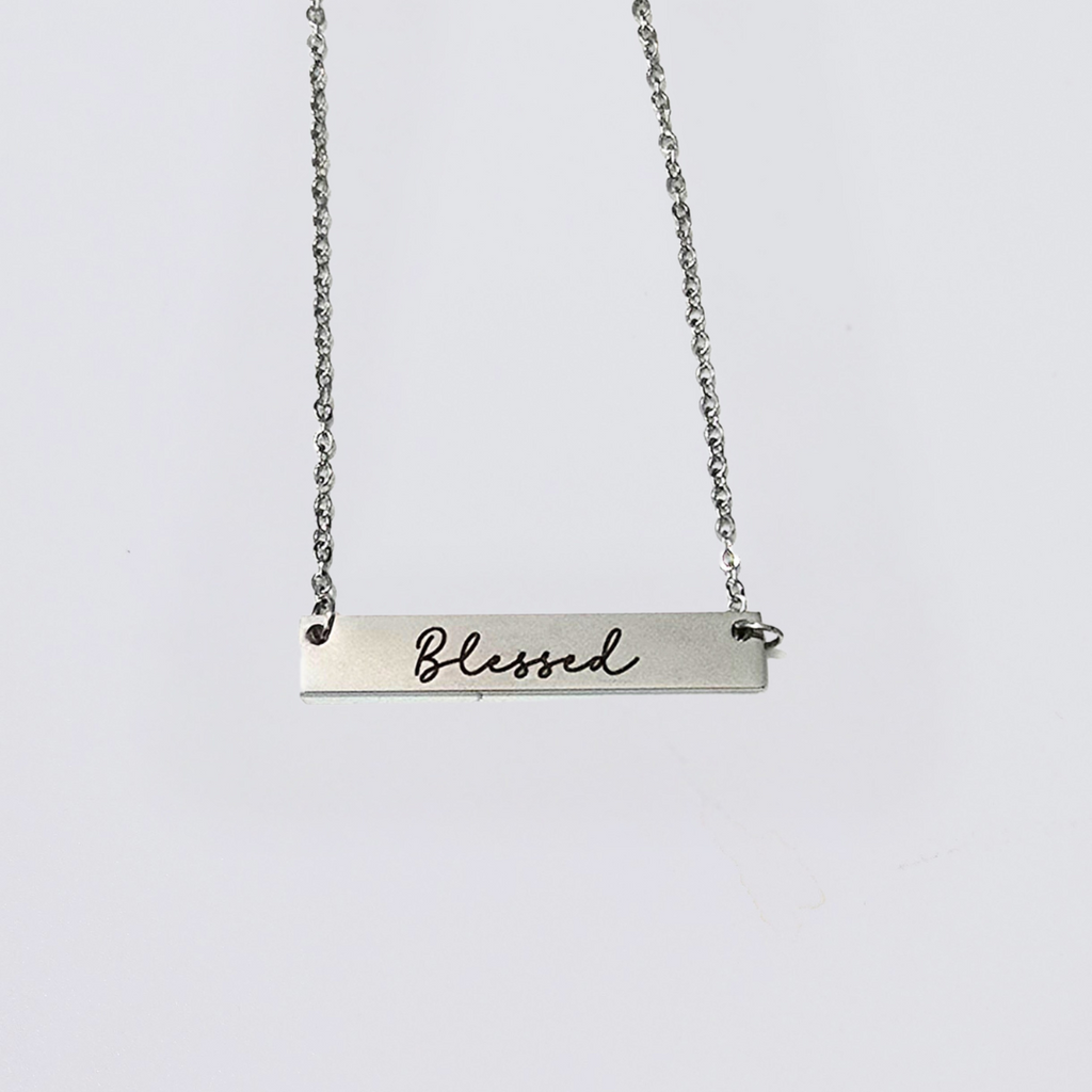 A collection of stainless steel bar necklaces with different motivational words engraved on them, displayed in silver, gold plated, and rose gold colors.