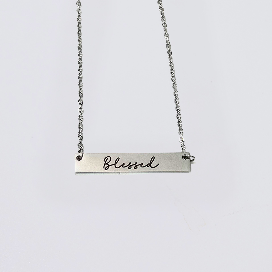 A collection of stainless steel bar necklaces with different motivational words engraved on them, displayed in silver, gold plated, and rose gold colors.