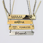 A collection of stainless steel bar necklaces with different motivational words engraved on them, displayed in silver, gold plated, and rose gold colors.